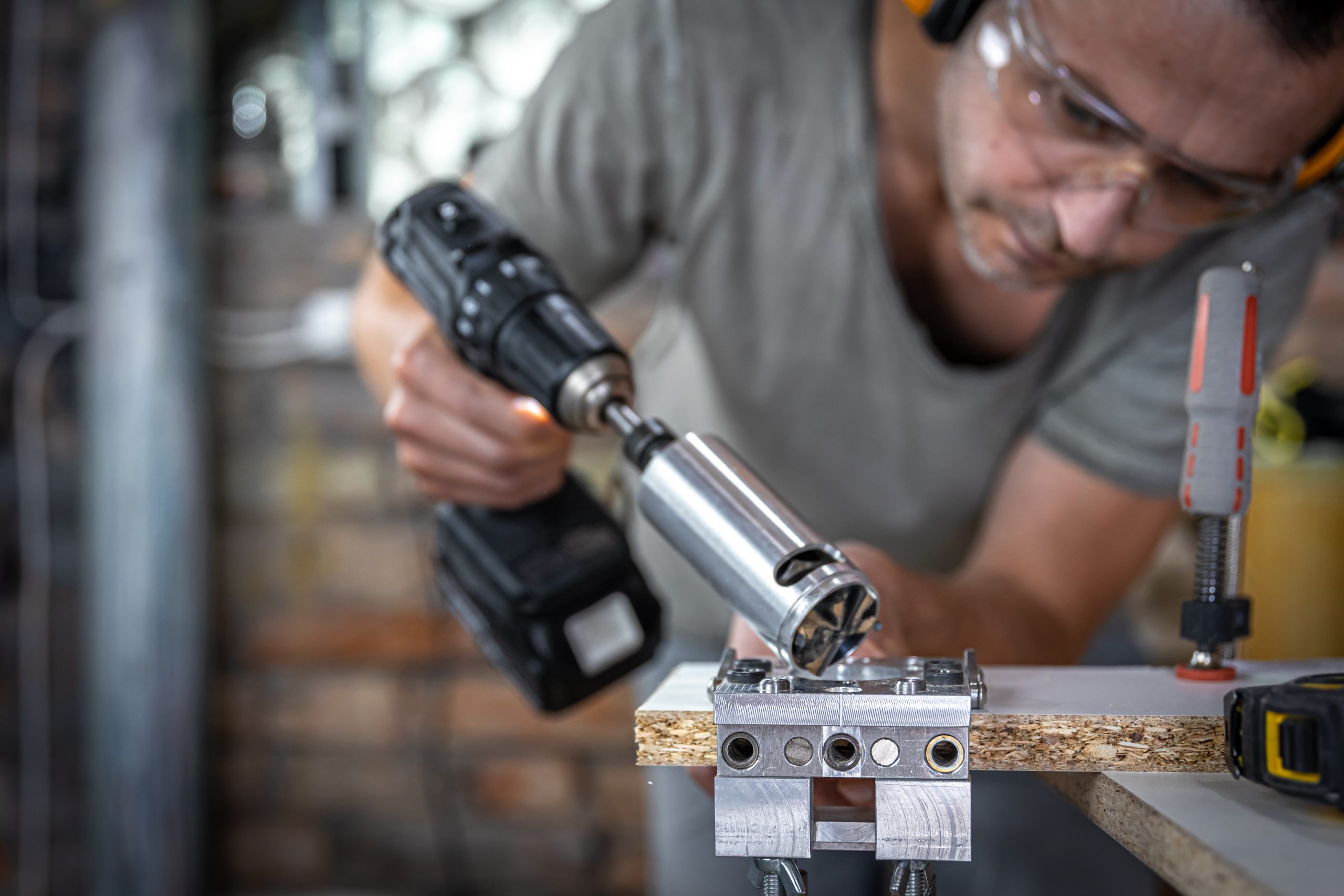 Pneumatic Tools a carpenter works with professional woodworking tools.