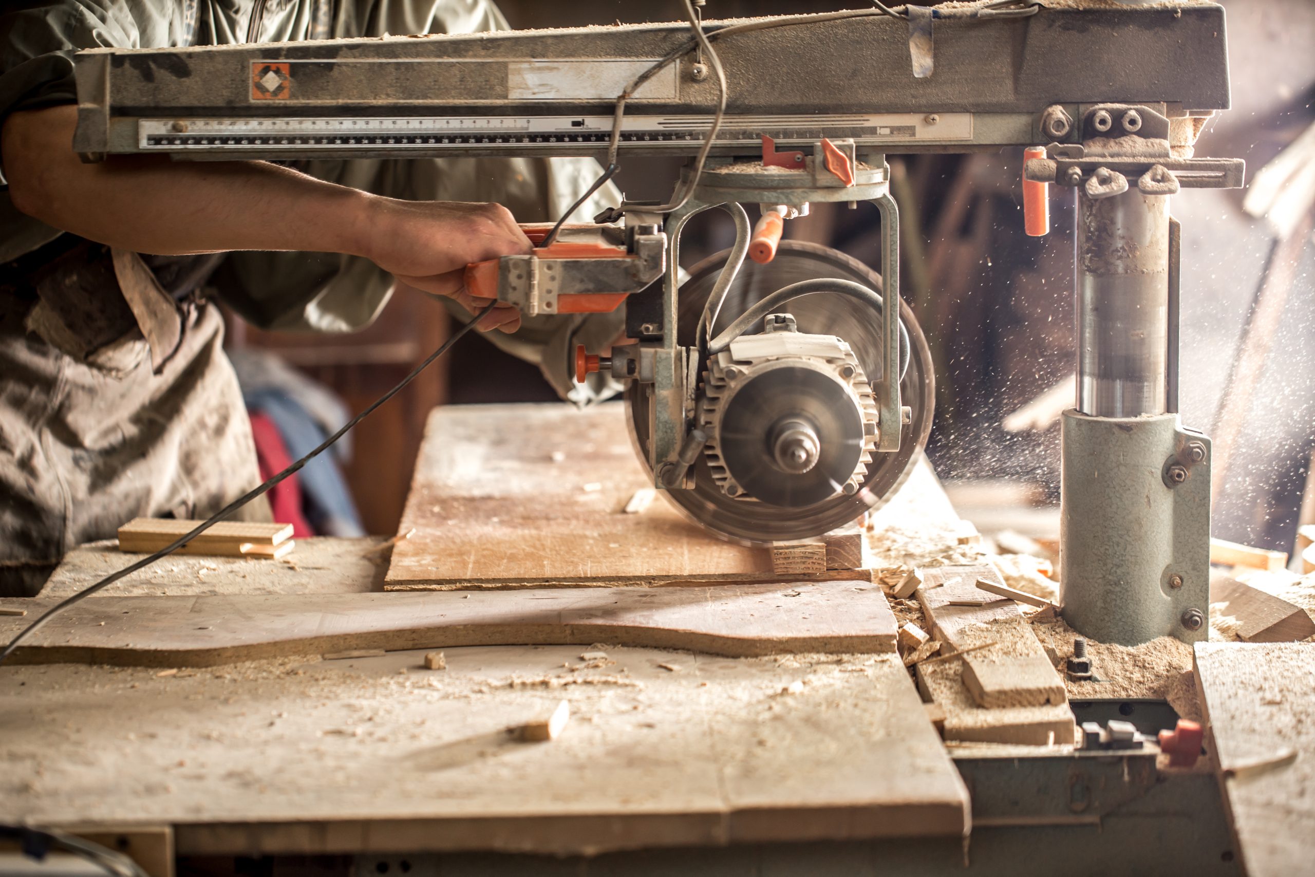 Machine Tools a man working with wood product on the machine